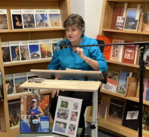 Services - Woman at desk behind microphone in book store