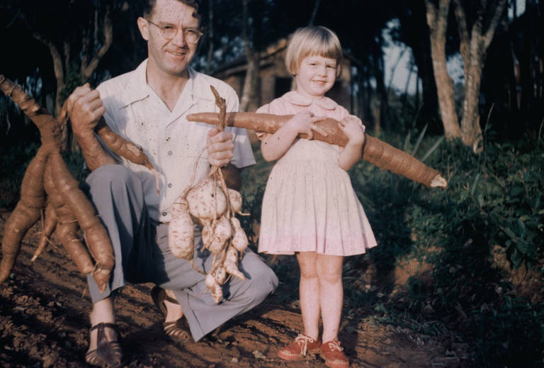 Marlena Fiol and her father holding vegetables