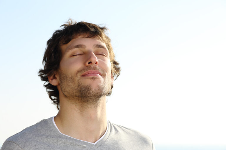 Man breathing with eyes closed - using your breath in meditation
