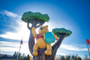 Winnie the pooh with the honey pot in a tree. My favorite day: today.